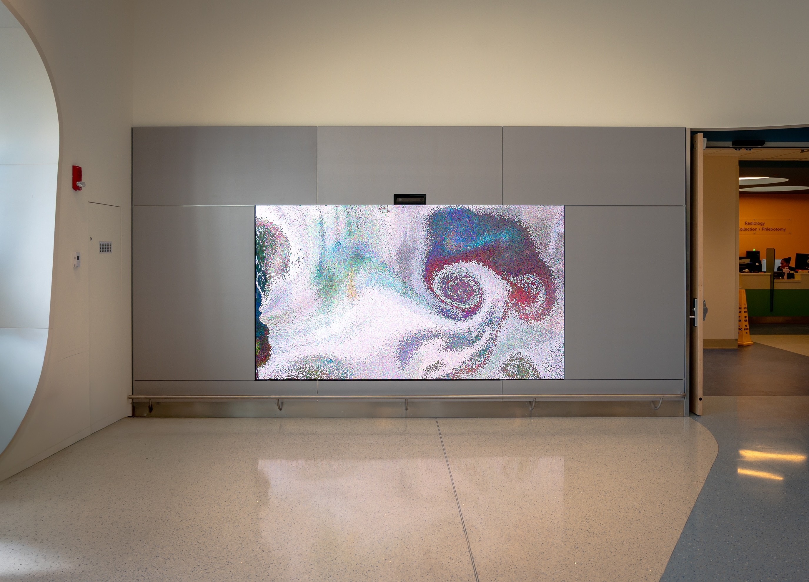 Boston Children's Hospital immersive LED display showing colorful abstract generative art integrated into architectural wall cladding